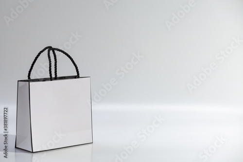 Empty white shopping bag on blue background, top view photo