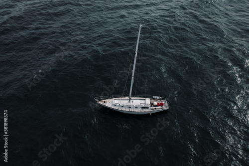An Abandoned Yacht Moored in a Dark Sea © Stock87