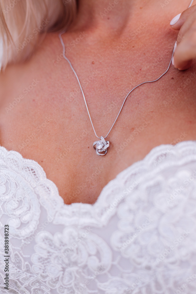 Portrait of  european woman in wedding dress wearing necklace and ring.  