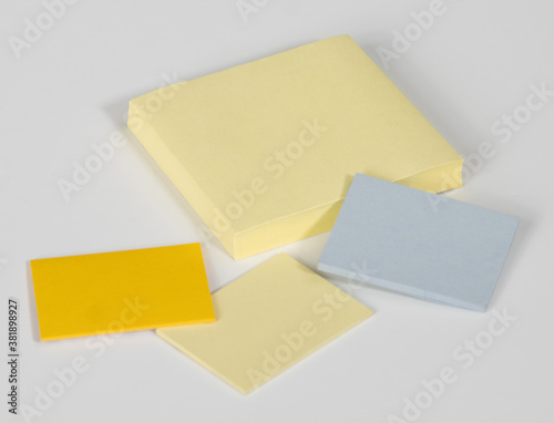 Sticky note pads of various shades of yellow and blue, for project file organization