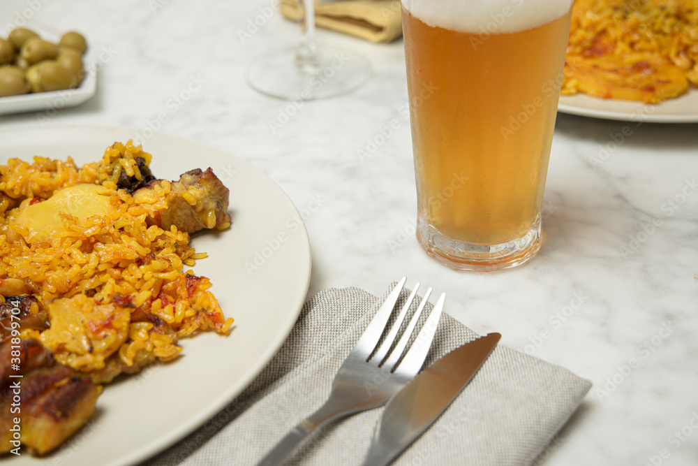 Two paella plates on a marble table ready to be eaten. Valencia, Spain Two paella plates on a marble table ready to be eaten. Valencia, Spain