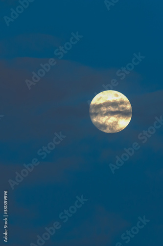 Full moon hiding behind the clouds. © Tanes