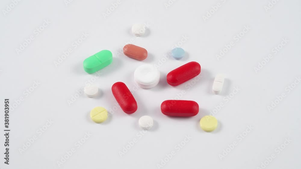 Different colorful pills and drugs rotating on a white background Different colorful pills and drugs rotating on a white background