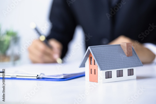 Businessmen and investors are trading, are making a contract to buy a home. Concept The real estate agent is satisfied with the mortgage contract, lease, purchase of a house.