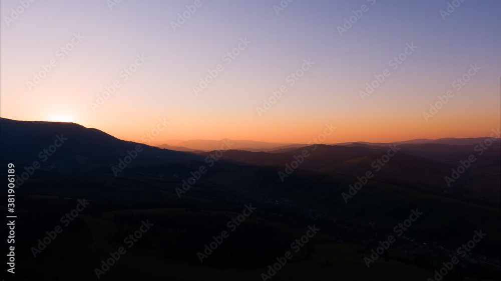 Sun setting over hills. Carpathian mountains in Ukraine.