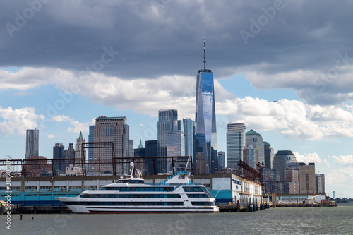 Lower Manhattan Skyline with Piers and a Boat along the Hudson River in New York City