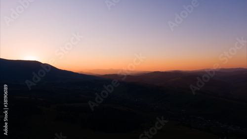 Sun setting over hills. Carpathian mountains in Ukraine.