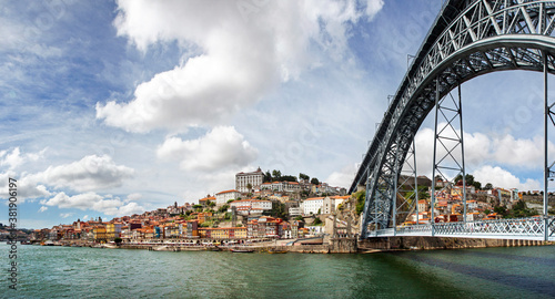 Low view on the Dom Luis I bridge from Vila Nova da Gaia, looking at the old town of Porto and the Douro river.