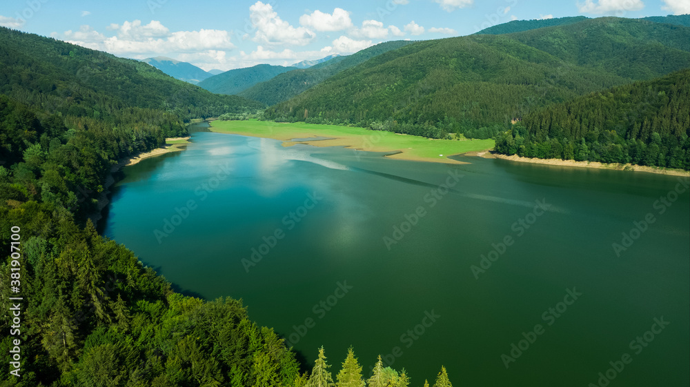 Aerial view of long Blue Lake that leading through the Mountains in Ukraine