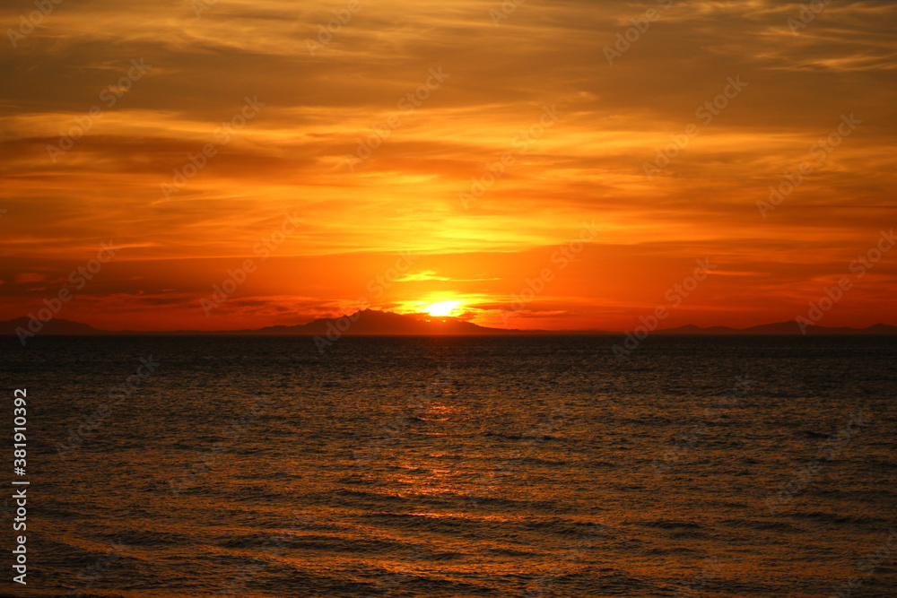 flaming orange sunset over south island NZ