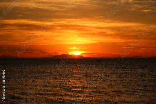 flaming orange sunset over south island NZ