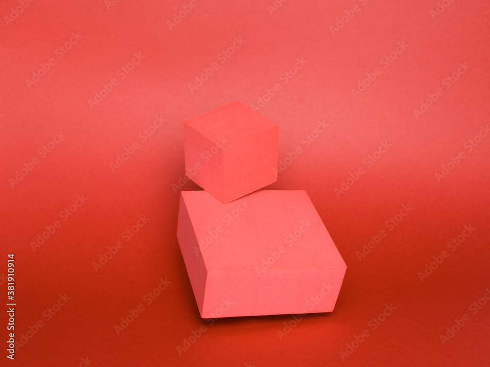 Photo of a bright podium (pedestal) of two cubes on a paper background. In red, with gradient and levitation. Advertising place. Blank product stand and abstract background with light. Photo of a bright podium (pedestal) of two cubes on a paper background. In red, with gradient and levitation. Advertising place. Blank product stand and abstract background with light.