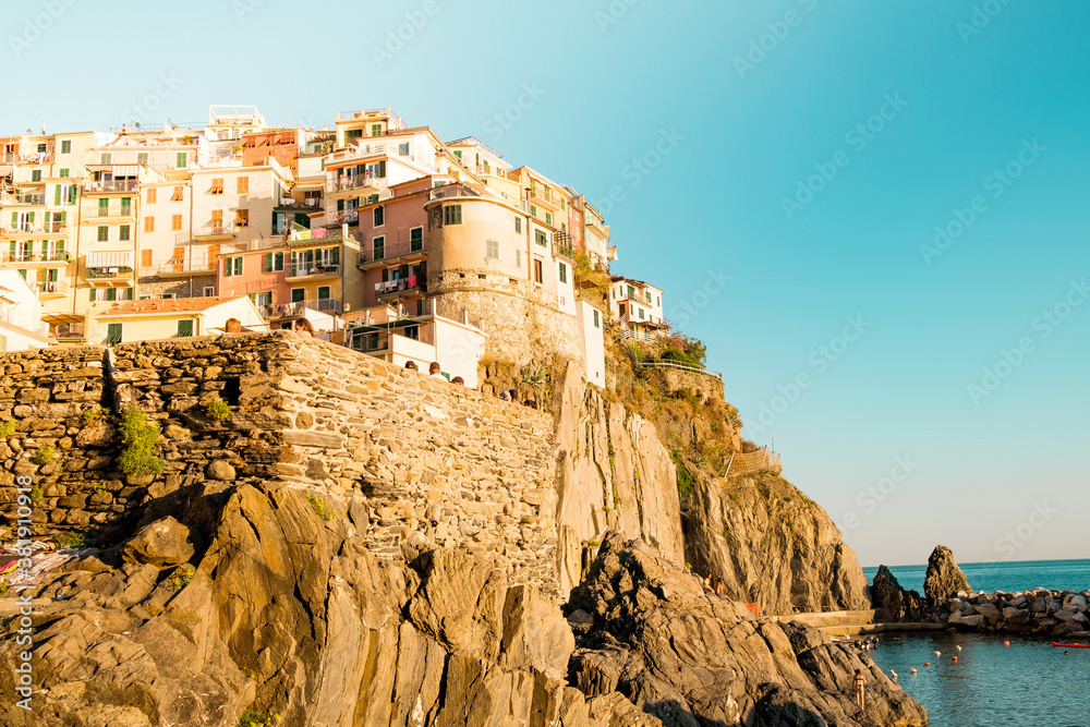 romantic panoramic view of Manarola village in Cinque Terre national park in Italy, in the middle of the mountains of the coast. Sunny holiday summer day in Italy
