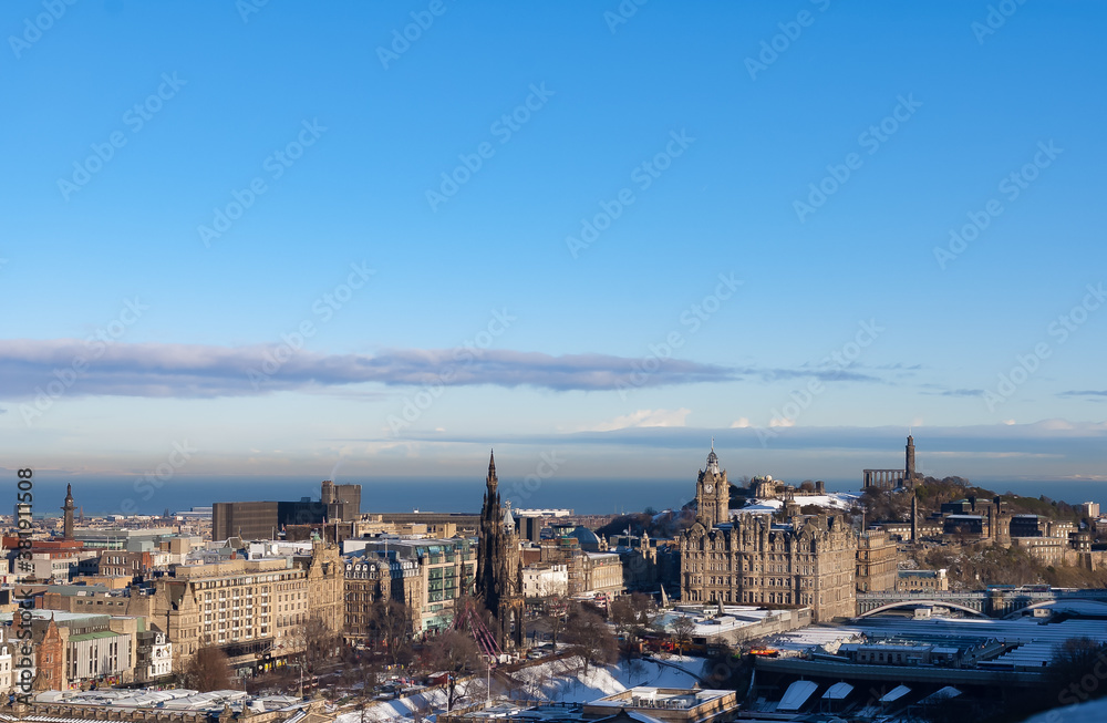 landscape of edinburgh city in winter, sunny, blue sky, snowfall