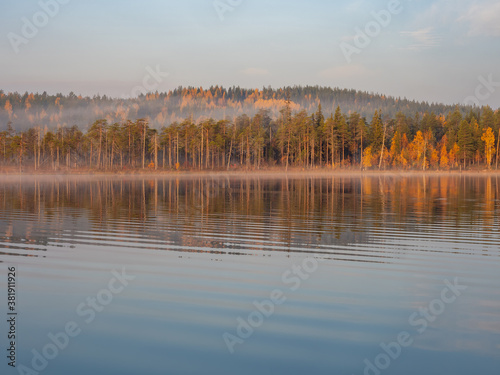 Sunrise time early in the morning with a fog over the lake in Karelia, northwest of Russia