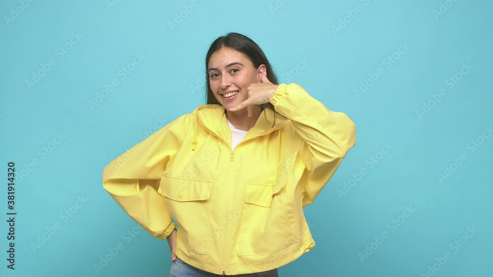 Young caucasian woman showing a mobile phone call gesture with fingers