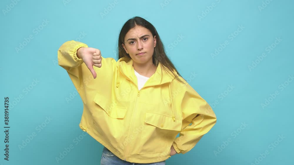 Young caucasian woman showing a dislike gesture, thumbs down, disagreement concept Young caucasian woman showing a dislike gesture, thumbs down, disagreement concept