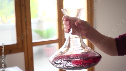 Red wine decanted in a glass decanter for the oxygenation of the vintage wine.