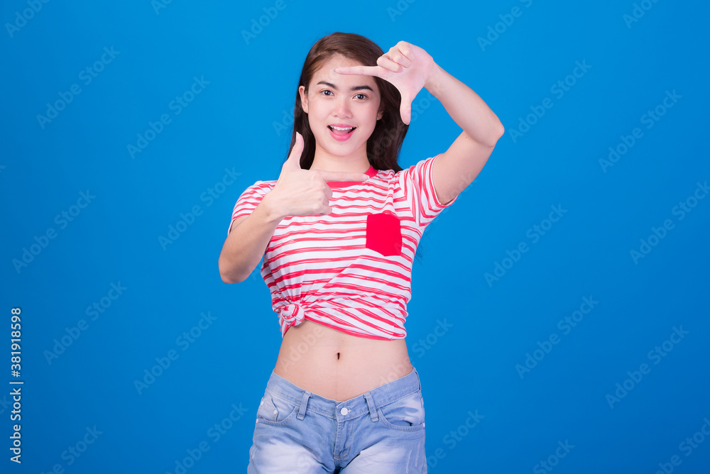 Portrait of beautiful asia young woman, on blue color background with copy space. Human face expressions, emotions feelings, body language,beauty and fashion concept.