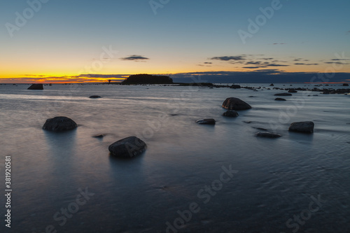 Twilight sunset at summer. Baltic sea coast with boulders.