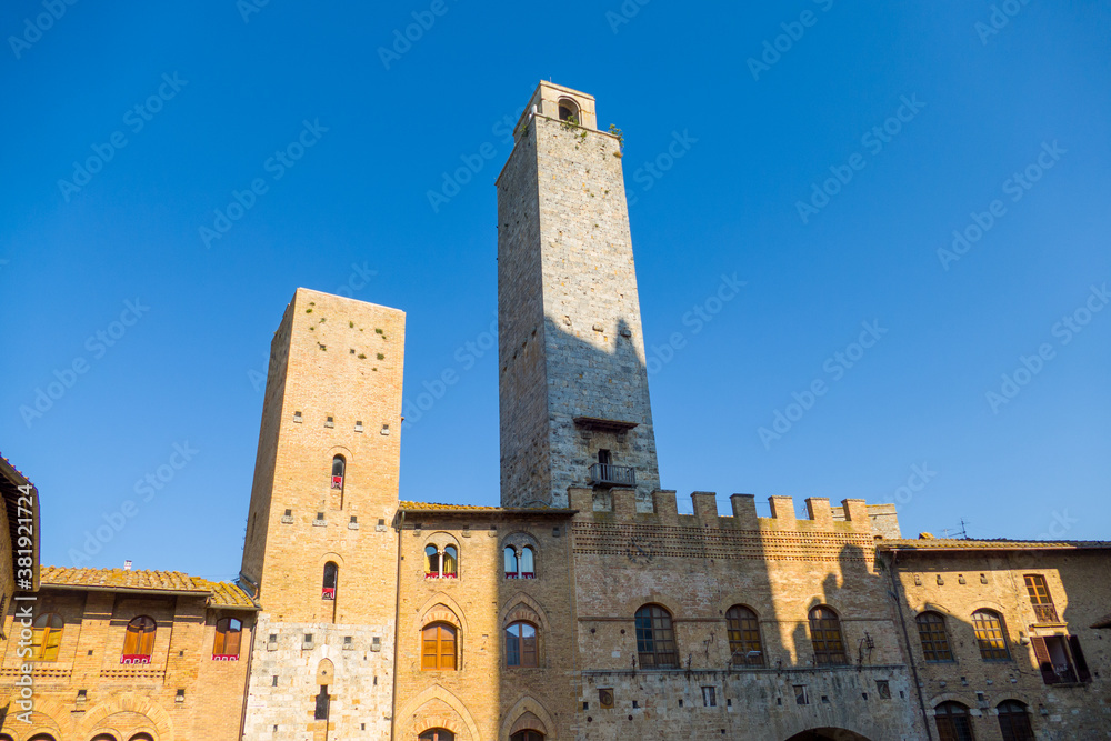 Picturesque View of famous Piazza del Duomo in San Gimignano at sunset, Tuscany, Italy
