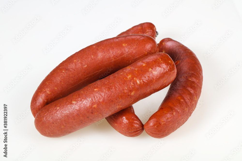 Tasty meat sausages over white background