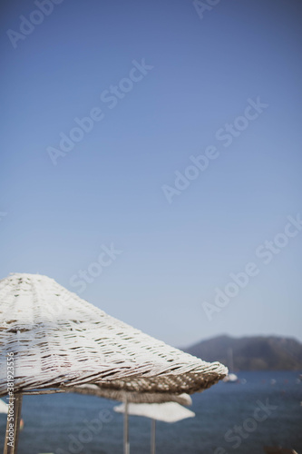 Bamboo beach umbrella on the background of the sea  beach.