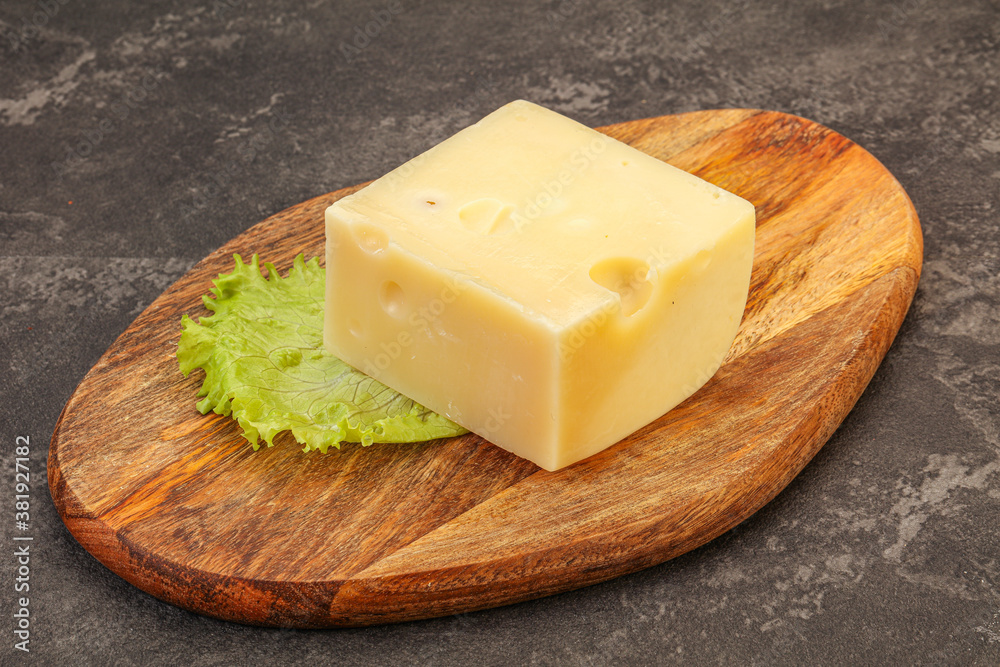 Emmental cheese over wooden board Emmental cheese over wooden board