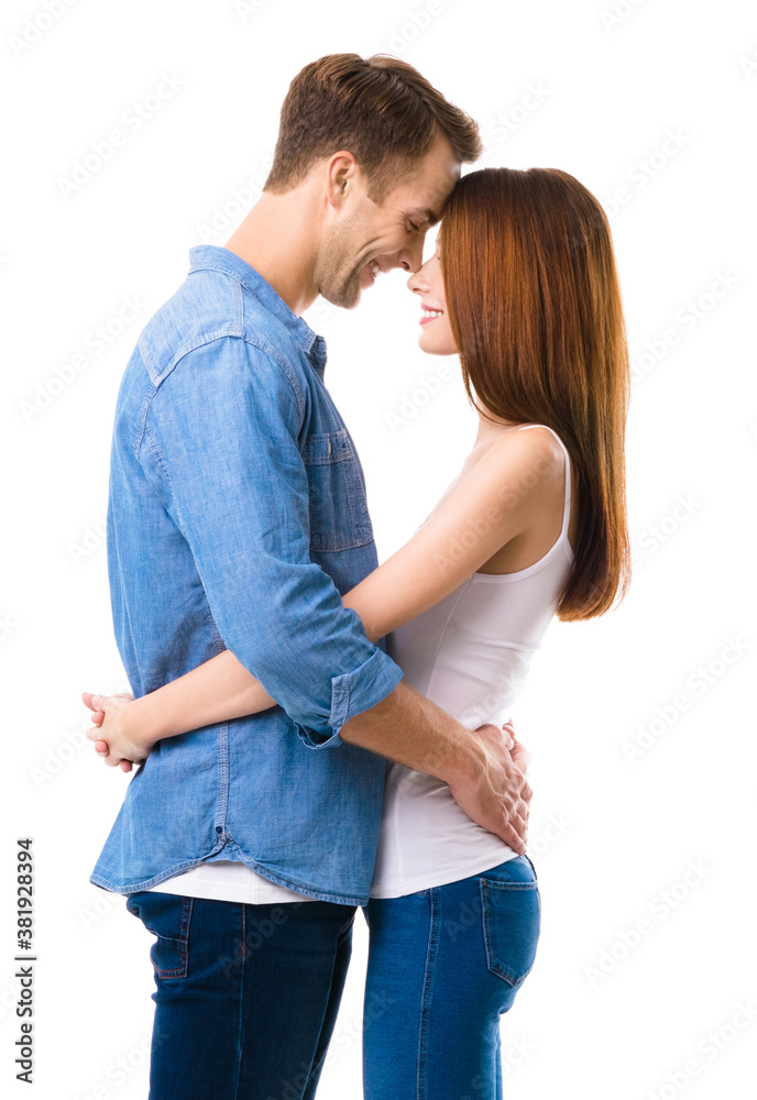 Profile side of smiling happy couple. Portrait picture of standing close and looking at each other models in love studio concept, isolated against white background. Man and woman posing. Profile side of smiling happy couple. Portrait picture of standing close and looking at each other models in love studio concept, isolated against white background. Man and woman posing.