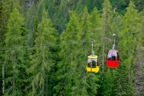 Mountain chairlift on the background of green pine forest