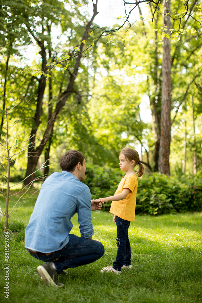 Single father in the park with his cute little daughter