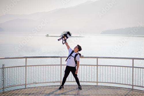 young asian guy have a big smile with his vlog