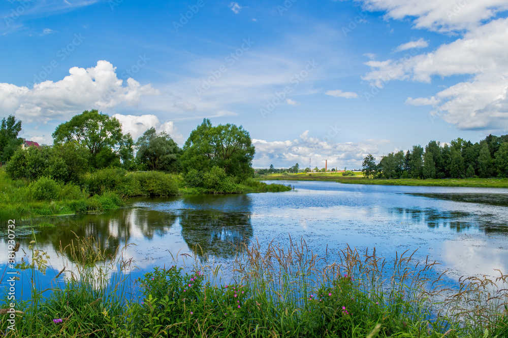 Blue sky and white clouds are reflected in the water. Beautiful ...