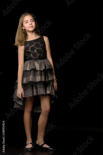 Beautiful young teen girl studio photo on black background