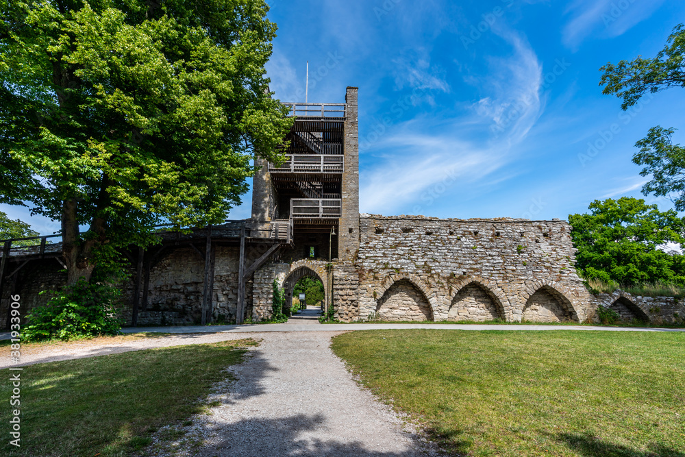 Beautiful rural summer view of an ancient medieval brick tower and defense wall surrounding the city of Visby Gotland, Sweden. Beautiful rural summer view of an ancient medieval brick tower and defense wall surrounding the city of Visby Gotland, Sweden.
