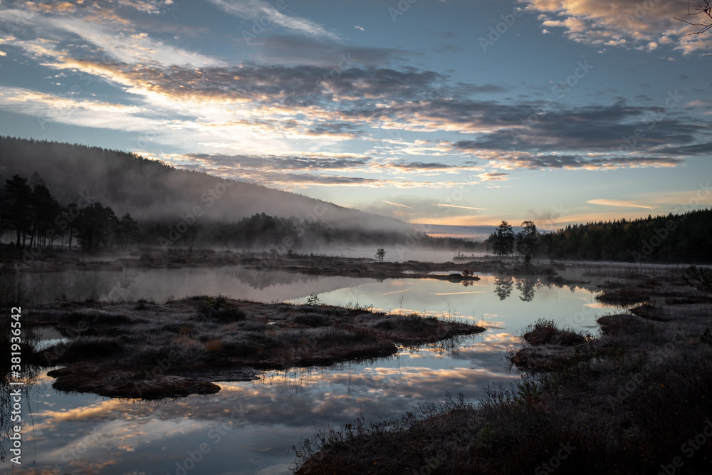 Picturesque Landscape in Norway with Cloudscape and Mist Above Water