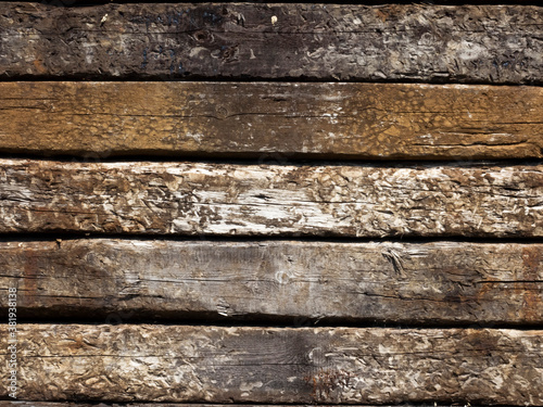 Rustic, textured, timber sleepers piled on top of each other as a background