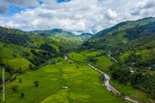Fotografie Aerial view, rural villages in the valley and agriculture, rice fields for cultivation in Nan, Thailand