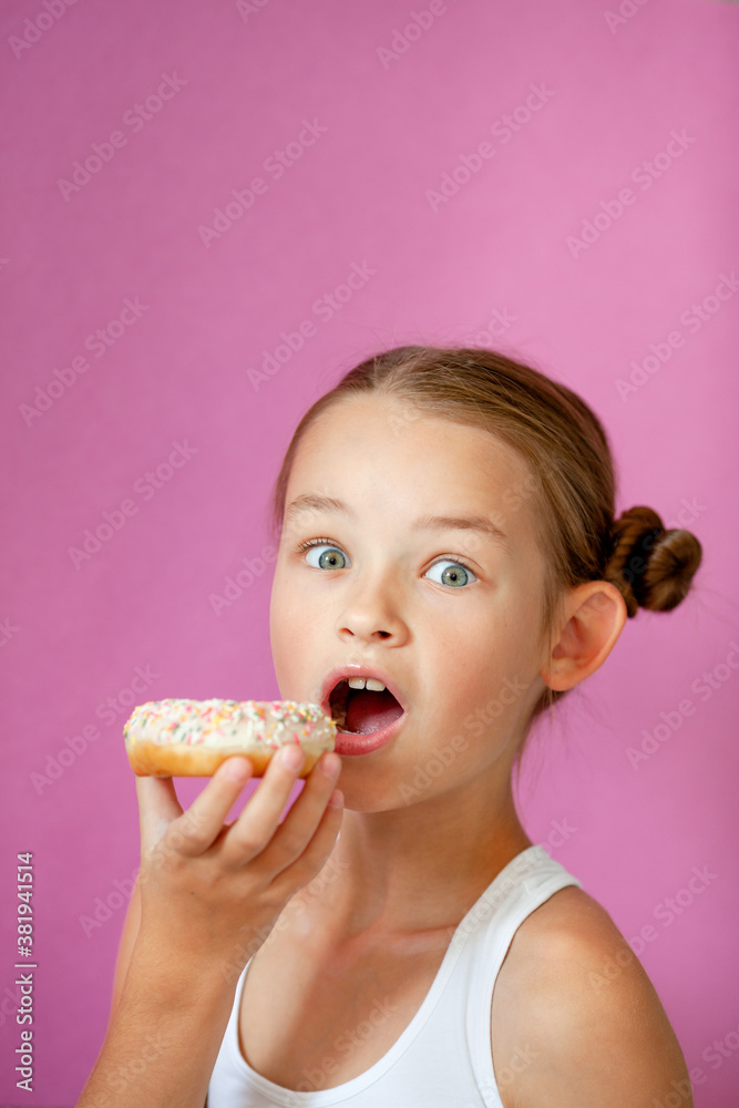 cute girl holding an appetizing glazed donut in her hands cute girl holding an appetizing glazed donut in her hands