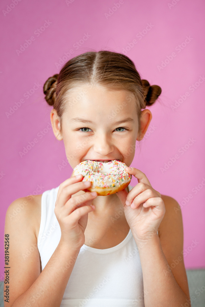 cute girl holding an appetizing glazed donut in her hands cute girl holding an appetizing glazed donut in her hands