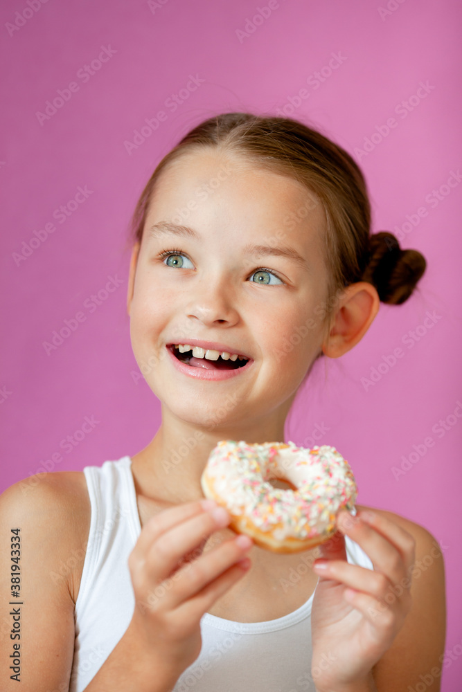 cute girl holding an appetizing glazed donut in her hands cute girl holding an appetizing glazed donut in her hands