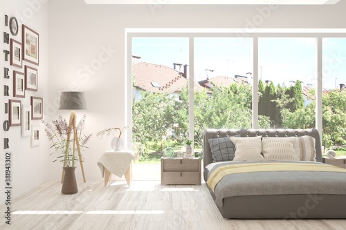 Stylish bedroom in white color with summer landscape in window. Scandinavian interior design. 3D illustration © AntonSh