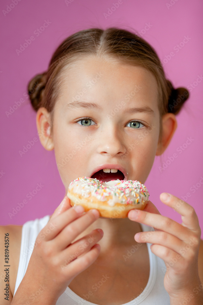 cute girl holding an appetizing glazed donut in her hands cute girl holding an appetizing glazed donut in her hands