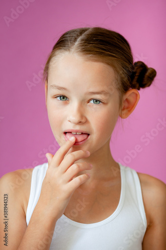 cute girl licks her finger after something tasty