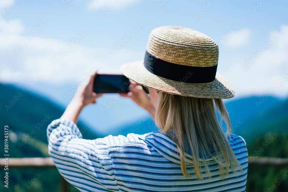 Woman taking picture of hill