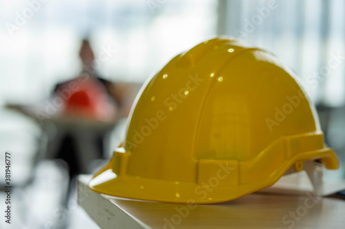 Caucasian engineer with safety hard hat meeting in constructuion site. social distancing new normal concept.