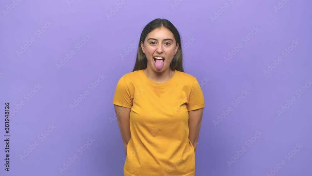 Young caucasian woman funny and friendly sticking out tongue Young caucasian woman funny and friendly sticking out tongue