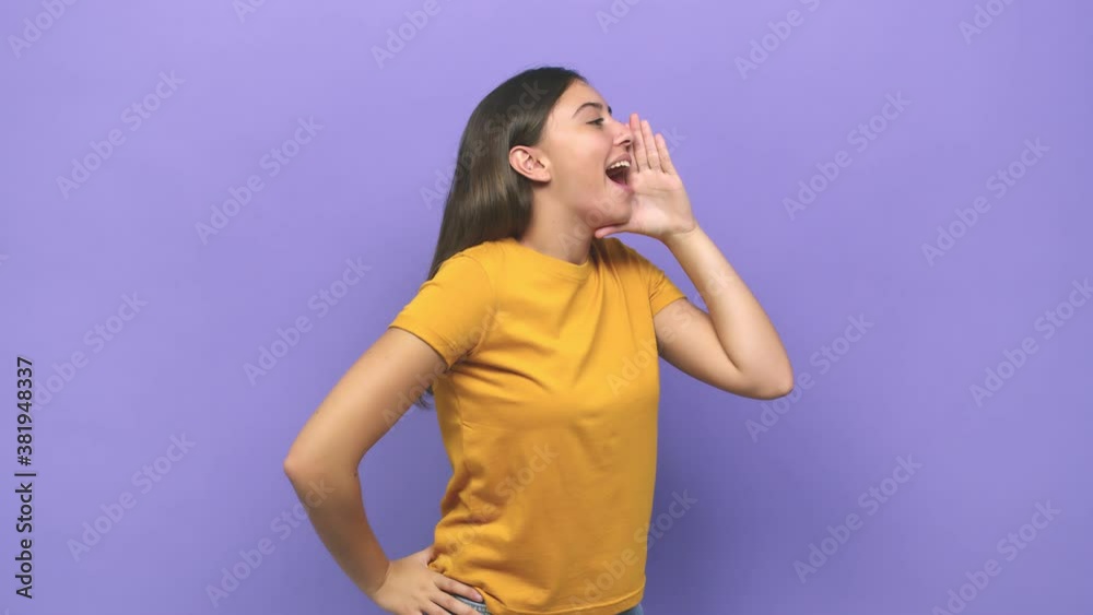 Young caucasian woman shouting and holding palm near opened mouth Young caucasian woman shouting and holding palm near opened mouth