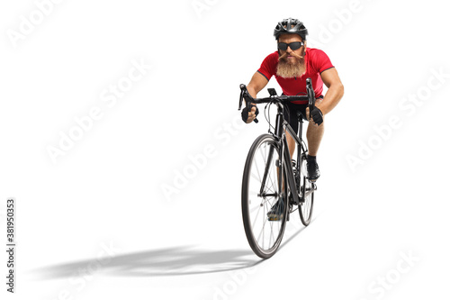 Bearded cyclist with helmet and glasses riding a road bicycle