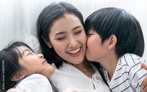 Asian mom playing with her son and daughter, They smile happily, Love, Family ties, Single Mother.